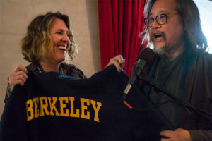 Shannon Jackson, associate vice chancellor of art and design, presents alum and director Stan Lai with a Berkeley sweatshirt at a pre-opera event in the Dress Circle Lounge at the San Francisco Opera House. (UC Berkeley photo by Kyle Ludowitz)