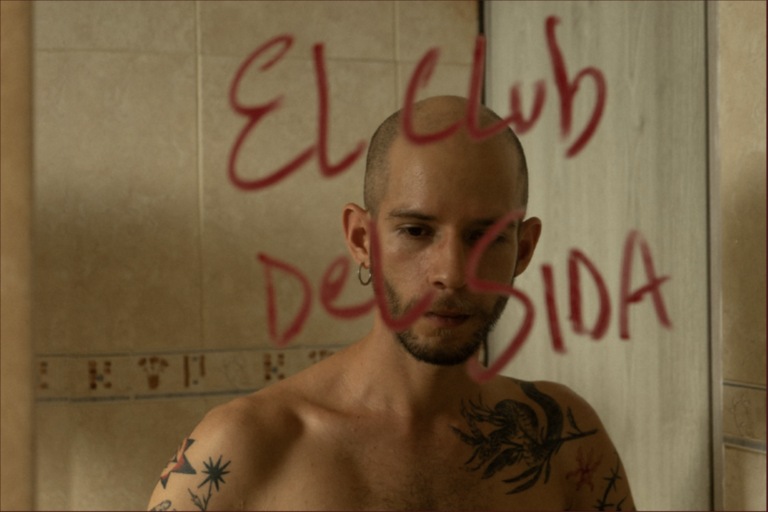 man looking in mirror with red writing on it