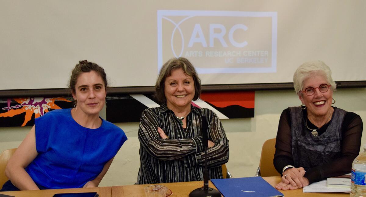 Three people sitting at a panel table with the ARC Arts Research Center UC Berkeley logo projected behind them.
