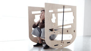 Artist sitting in wooden structure
