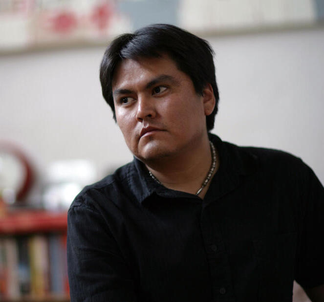 image of man with brown hair and eyes in a black shirt