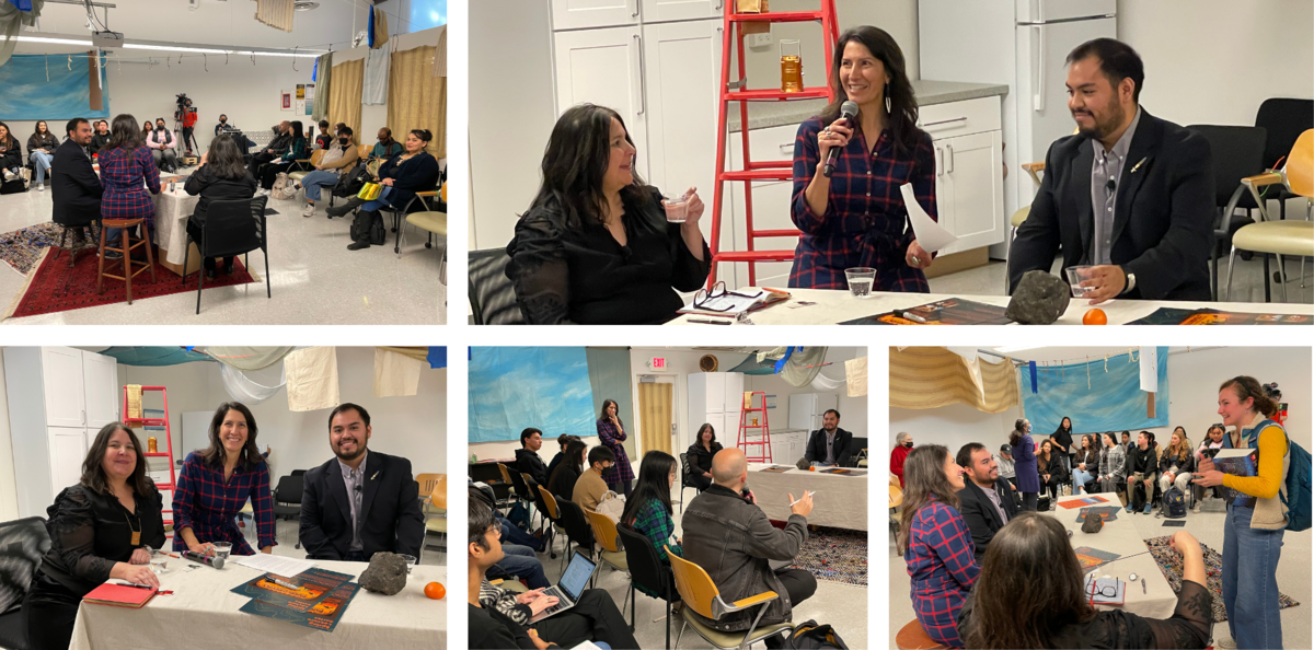 A community event with speakers and audience in a decorated indoor room. Panelists at a table converse and interact with participants.