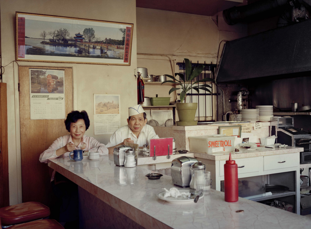 Old couple sits at a diner counter