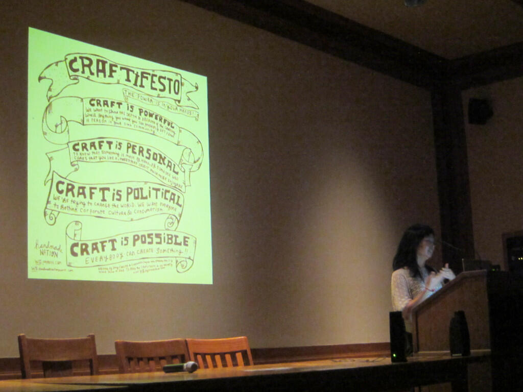 Person presents at lectern with "Credit Fiesta" projected behind them