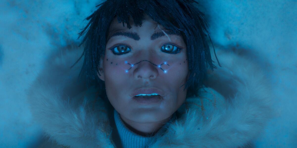 person's face against blue background with stars across their nose