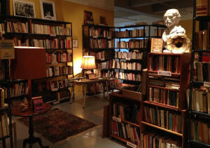Dimly lit library with a statue of a bust of a man