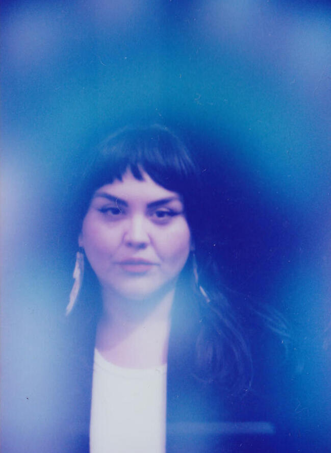 Indigenous woman against blue background