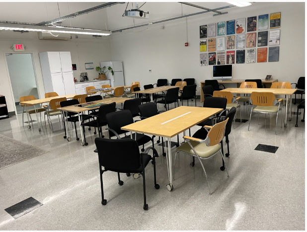 room set up with tables and chairs for a workshop