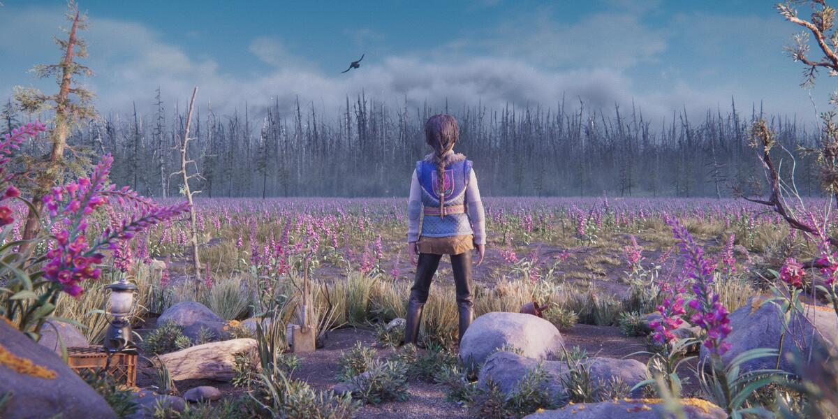 young woman standing with her back to viewers in a field of flowers