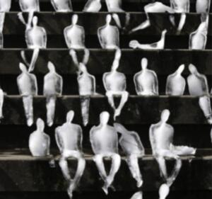 Ice sculptures of human figures sitting on a dark-brick staircase.