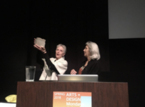 Two people at a podium, one holding a translucent object.